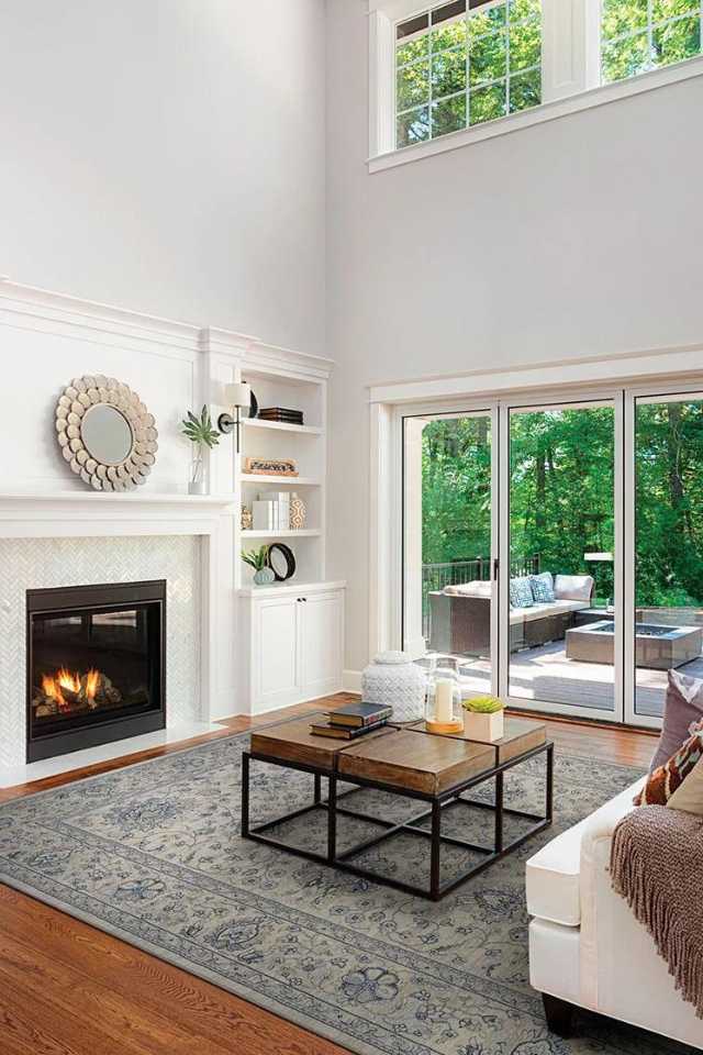 blue persian area rug in living room with fireplace